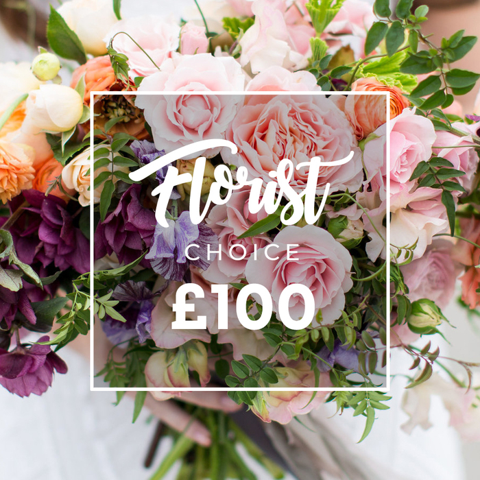 A full-frame, hand-tied bouquet fills the image with luxuriant blooms and verdant foliage, presented against a softly blurred background so that every petal and leaf remains the focal point. Large, soft pink garden roses dominate with lush, ruffled petals reminiscent of antique blooms, their layered centres catching the light. Deep plum-coloured hellebore-like flowers cluster for contrast, while delicate, striped pale purple-and-white sweet peas add a filigree of colour and movement. Interspersed peach and coral ranunculus-style flowers and small creamy white sprays provide luminous accents, and an abundance of mixed greens - from narrow trailing strands to broader leaves - gives the composition a garden-foraged, organic feel. The bouquet is held gently at the bottom by hands in a faint white sleeve, suggesting careful, human craftsmanship and a freshly made, hand-tied technique.Superimposed centrally is a thin white rectangle containing the elegant script words Florist Choice, with CHOICE in smaller uppercase letters beneath and a clear ?100 in large, bold sans-serif numerals at the bottom - an unmistakable label of a florist-selected product and price. The image evokes a refined yet natural sentiment, perfect for weddings, milestone anniversaries, or as a luxurious, thoughtful gesture. It suggests the sort of arrangement you might choose for a celebration near Canonbury's leafy streets or to send to someone who appreciates a quiet, artful bouquet gathered with local care.