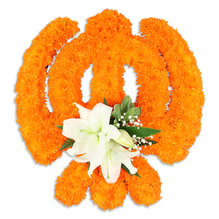 A carefully arranged floral Ik Onkar symbol occupies the centre of a clean white field, its traditional form rendered in vivid orange and serene white with precise, artisan attention. Thousands of small bright orange marigold blossoms are packed together to form the distinct strokes of the Ik Onkar-the upright element, the sweeping crescent-like curves and the small dot-each bloom contributing to a textured, almost woven surface that catches light and throws soft shadow into the symbol's recesses. Nestled at the lower centre of this orange composition is a composed cluster of white lilies: at least two prominent blooms are fully open, their elegant petals unfurling to reveal pale green and yellow stamens, while smaller buds and slender pointed leaves frame them. The lilies' cool cream tones and gentle fragrance contrast beautifully with the marigolds' warm, peppery scent; tiny sprigs of baby's breath and glossy green foliage add air and definition, softening the orange and lending a devotional tenderness to the piece. A subtle drop shadow beneath the arrangement suggests it is a freestanding tribute, created for placement on a table or altar, and the soft, even lighting emphasises the three-dimensionality of the floristry. This floral Ik Onkar would be fitting for observances of Guru Nanak Jayanti, Vaisakhi, or community services held in local Gurdwaras and halls across Canonbury and broader Islington, and it carries the upright simplicity of the message ''God is One'' in living blossoms. Local neighbours walking from Essex Road or Canonbury Square would recognise this as a crafted offering of faith, care and shared cultural celebration.