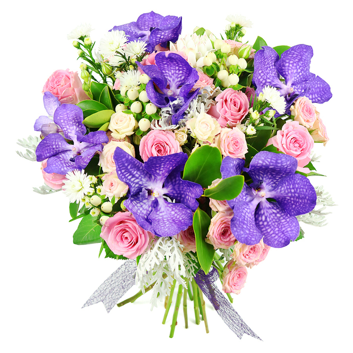 This professionally crafted bouquet, displayed against a bright white background, brings together the drama of tropical orchids with the softness of traditional garden roses. Large Vanda orchids in saturated purple-blue dominate the composition, their petals broad, slightly ruffled at the edges, and covered in an intricate network of pale speckles and veins that draw the eye inward. These exotic blooms are thoughtfully spaced throughout the arrangement, ensuring their striking presence is visible from every angle. Between them, blush pink roses provide a gentle counterpoint, some just beginning to open with cupped, expectant centres, others fully unfurled into generous spirals of petals that feel lush and romantic. Cream-toned spray roses appear in smaller clusters, filling the gaps and creating an impression of abundance without overwhelming the senses. Scattered among the main flowers are small white filler blossoms, reminiscent of asters or miniature daisies, and rounded white hypericum berries that introduce a polished, bead-like texture. A halo of dusty miller leaves, in soft silver-grey, offers a cool, velvety contrast to the glossy dark green foliage that forms the bouquet's backbone. The leaves frame the arrangement with a natural, flowing outline, giving it structure while still feeling airy and light. At the base, the stems are tightly gathered and wrapped with a shimmering silver-purple ribbon, semi-sheer and reflective, with ends that fall gracefully like gentle streams. The bouquet's palette of purples, pinks, whites, and silvery greens creates a refined yet approachable elegance, perfect for same-day flower delivery to homes and studios around Canonbury, whether to mark an engagement, an anniversary dinner near Newington Green, or simply to brighten a quiet corner with a sense of contemporary floral artistry.