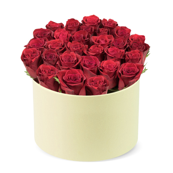 An opulent circle of crimson roses fills a round cream-colored box with a soft matte finish, creating a dense dome that rises just above the rim. Two dozen or so velvety blooms, with petals tightly furled and a luxurious depth of color, sit amid slim green foliage that threads through the heads, adding a natural highlight to the velvet red.
Seen against a pristine white background and photographed from a slightly elevated three-quarter angle, the arrangement communicates sophistication and exclusivity. It's the kind of gift that suits anniversaries, Valentine's Day, or a milestone celebration-a refined statement carried by a premium packaging design reminiscent of a hat box. In Canonbury's close-knit community, such a bouquet pairs beautifully with same-day delivery to nearby Islington, Dalston, and surrounding streets, bringing a touch of luxury to everyday life.
Craftsmanship matters here: each bloom is positioned by hand, careful to preserve balance and a sense of intimate abundance. The subtle greenery and the creamy neutral container enhance the intensity of the red, while the absence of visible stems or leaves on the top emphasizes lush fullness. This arrangement is a timeless, romantic gesture-ideal for Valentine's, anniversaries, or a poetically elegant gift, available for delivery across Canonbury and adjacent neighborhoods.