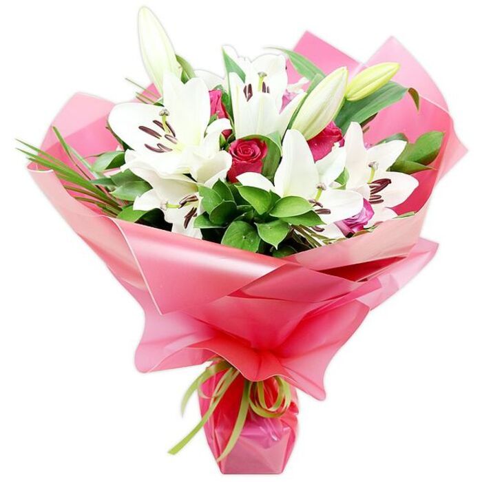 This image presents an opulent bouquet of pristine white lilies and rich red roses, carefully arranged to highlight every curve and texture, and set crisply against a bright white background typical of professional product photography. Dominating the composition are several large white Oriental lilies, each bloom unfolding in a trumpet-like shape, their petals slightly ruffled at the edges and glowing softly as if lit by gentle studio lighting. In the heart of each lily, deep reddish-brown anthers perch on fine filaments, creating a striking contrast against the pure white petals and hinting at a warm, heady fragrance. Scattered between the lilies are clusters of deep red roses in varying stages of opening, from tightly cupped buds to partially unfurled blossoms, adding a sense of movement and romantic drama. Surrounding the flowers is a generous collar of verdant greenery: broad, glossy leaves that catch reflections of light and slimmer, spiky blades that arch gracefully, giving the bouquet a full, layered structure. The stems are wrapped in a large swathe of shiny, translucent bright pink cellophane, drawn up around the base of the blooms into soft folds and creases that shimmer and reflect the colours of the flowers. At the bottom, a narrow lime green satin ribbon is neatly tied, its sleek texture and fresh colour adding an eye-catching accent that modernises the look. This bouquet feels perfectly suited to a thoughtful delivery across Canonbury and nearby Islington, whether to celebrate a birthday on St Paul's Road, mark an anniversary near Canonbury Square, or simply bring a burst of beauty into a home overlooking the leafy streets and hidden gardens of the neighbourhood.