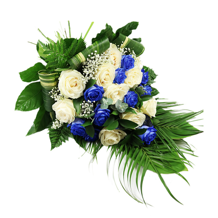 A luxurious cascading funeral spray of blue and white roses lies against a crisp white background, its form sweeping gently from a broad, rounded top into a refined, elongated tail. The composition is densely planted with generous, full-headed roses, each blossom open enough to reveal its layered petals. Rich sapphire blue roses, striking and almost luminous, are interspersed evenly with ivory and off-white blooms, so no single colour dominates. This carefully balanced distribution creates a rhythm of cool blue and soft cream that draws the eye along the length of the arrangement, much like the quiet flow of people moving through Canonbury's peaceful residential streets on a reflective afternoon.

Nestled between the roses, fine clusters of white baby's breath offer a gossamer texture, appearing as tiny, star-like dots that lighten the composition. Surrounding the central blooms, a strong base of greenery gives depth and structure. Feathery ferns in fresh, bright green arc upward and outward at the top, while broad, glossy dark green leaves underpin the middle, providing a rich, almost velvety backdrop to the roses' softness. Long palm fronds emerge from the lower section, arching downward in slender, tapering lines that define the spray's signature cascading silhouette and guide the gaze toward the tip.

Scattered throughout are subtle accents of silvery, eucalyptus-like foliage, their cooler hue and rounded leaves adding nuance and a slightly misty tone. Several broad leaves are folded and wrapped into horizontal bands, creating refined, tailored details that hint at the practiced craftsmanship of florists serving Canonbury families. The overall impression is serene, formal, and deeply respectful-a blue and white rose tribute suited to funerals, graveside services, or memorial ceremonies held in local Islington venues, conveying themes of loyalty, peace, and gentle remembrance.