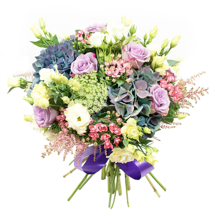 Brimming with artistry and evocative of Canonbury's leafy atmosphere, this radiant bouquet is a testament to expert floral curation. Anchored by cascading clusters of hydrangea-layered in moody indigo, teal, and muted amethyst-the arrangement is a visual tapestry reminiscent of the nuanced gardens surrounding Canonbury Square. Scattered throughout are roses in soft lavender and creamy white, their velvety petals elegantly unfurled, bringing romantic serenity and a hint of classic luxury. Plush white ranunculus enhance the bouquet's texture, their multi-petaled blooms softly contrasting with the robust hydrangeas. Slim stems of eustoma, crowned with pale yellow buds and half-open blossoms, introduce a flutter of ethereal lightness, calling to mind a gentle breeze sweeping through local green spaces. Sprays of vivid fuchsia-pink filler flowers and feathery pink astilbe add movement, framing the bouquet with dynamic, playful form and suggesting a wildflower walk along nearby New River Path. Delicate, lacy Ammi Majus peeks through with intricate green-white blooms, livening the arrangement with subtle detail. Lush dark-green foliage acts as an elegant accent, enhancing each bloom and highlighting the bouquet's fresh-picked allure. Tied at the base with a regal, wide purple satin ribbon, the bouquet is an inviting presentation-perfect for gifting, celebrations, or brightening a Canonbury home. Every element is carefully positioned to evoke abundance, romance, and the tranquil beauty of Canonbury life.
