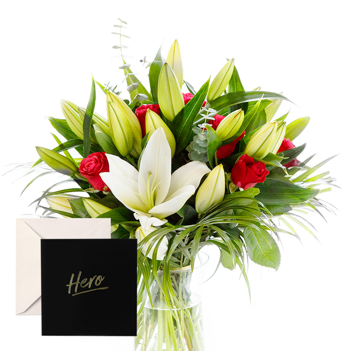 Near Canonbury and Islington's bustling Upper Street, this arrangement celebrates the joy of blending bold and serene elements. White lilies drift at the heart, luminous and airy, their satin petals catching soft morning light, while their green surrounds keep the composition grounded. Ruby red roses punctuate the design, each bloom a symbol of love and respect, nestled among lush, vivid green foliage. Unopened lily buds hint at new beginnings, and touches of eucalyptus and wispy grasses inject movement and a subtle herbal freshness. In the pale, natural light, the bouquet feels alive and uplifting, an ideal tribute to someone's strength or a significant achievement. The accompanying Hero card makes the gesture intimate and enduring, a testament to admiration and gratitude born in a local studio near Canonbury.

Ideal for celebrations, milestones, or quiet remembrances, this bouquet can brighten a room in Canonbury, Islington, or nearby Dalston, with same-day delivery available to friends and family across the area. The craftsman touch of Canonbury Flowers is evident in the careful balance of white and red, the texture of the leaves, and the way light rests on each petal. It is a living note of appreciation that honours both the person and the place where they live-the city's little corners where strength and kindness grow.