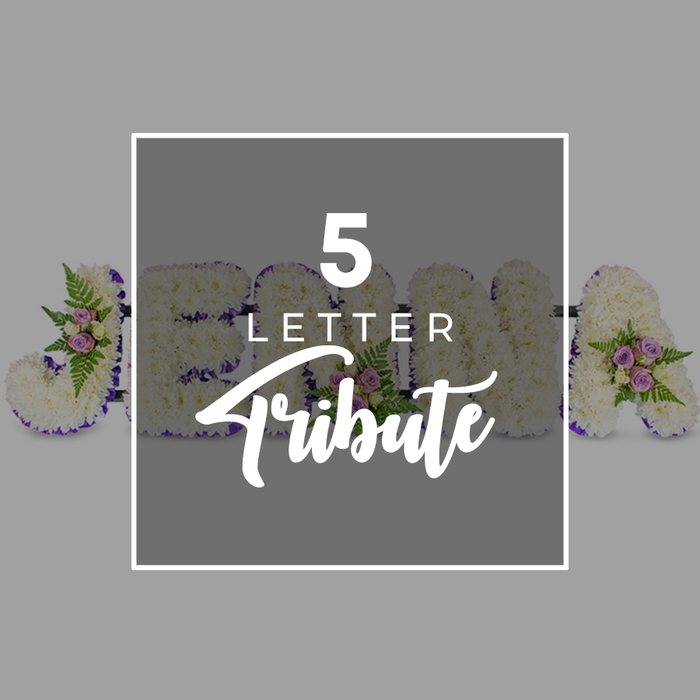 The photograph presents a carefully arranged five-letter floral tribute, a style often chosen by families in Canonbury who wish to spell out a loved one's name in flowers for a funeral or memorial. Set against a calm, light grey background, the letters rest in a straight horizontal line, each one crafted from a solid bed of white chrysanthemums. The blossoms, small and closely packed, give the surface of each character a plush, continuous texture, with the occasional petal catching the light to create a gentle sheen. Around the edge of every letter, a band of deep purple satin ribbon is precisely pleated, framing the white flowers with a rich, respectful border that adds contrast without overpowering the softness of the design. Scattered thoughtfully along the letters are small, graceful posies of accent blooms: blush pink and soft mauve spray roses, some in tight buds and others slightly open, are nestled among fresh green fern fronds and fine, leafy foliage. These clusters bring visual depth and a subtle sense of movement, like tiny garden vignettes dotting the pure white canvas. The name appears to read JOHN A, though the central area is partially veiled by a semi-transparent grey square overlay. This overlay, edged with a thin white frame, bears the words 5 LETTER in clear, uppercase white type, positioned above the word Tribute in a flowing script font that suggests personal care. The restrained palette of white, purple, and soft pastels, combined with the tidy layout and studio lighting, conveys a mood of quiet dignity and remembrance, much like a custom letter tribute one might order from a local Canonbury florist for delivery to a church service or graveside gathering.