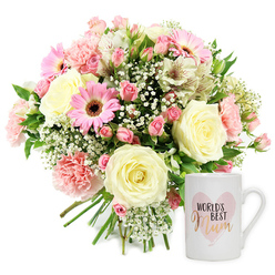 Carefully lit product image showing a tender Mother's Day gift set on a pure white background, capturing the quiet elegance of a bouquet and mug pairing you might receive from a local Canonbury florist. On the left, a generous, domed bouquet overflows with soft, feminine colour. Large cream and pale yellow roses form the heart of the design, their layered petals plush and gently cupped as if just opened that morning. Around them, powder-pink carnations with frilled edges mingle with clusters of deeper pink spray roses, adding depth and a sense of abundance. Cheerful bright pink gerbera daisies face outward, their neat, dark centres anchoring the composition and echoing the playful spirit of family celebrations along nearby Upper Street. Slender white alstroemeria blooms, brushed with fine reddish-brown streaks, stretch outward like small stars, while airy stems of white baby's breath weave through, creating a soft, cloud-like halo around the main blooms. Fresh, mid-green foliage appears in small glimpses, giving the impression of garden-fresh stems just carried in from a Canonbury back garden. The gathered stems are visible at the base, clearly hand-tied and ready to be placed in a favourite vase at home. To the right, a pristine white ceramic mug stands upright, its surface smooth and glossy. A watercolour-style pink heart is printed on the front, and inside the heart the phrase "WORLD'S BEST" appears in crisp black text above the word "Mum," rendered in flowing, metallic gold script that subtly catches the light. The image radiates warmth, appreciation, and homely comfort, perfect for marking Mother's Day, a birthday, or a thoughtful thank-you with local flower delivery across Canonbury.