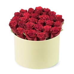 From the outset, this luxurious bouquet unfolds as a circle of deep red roses, roughly two dozen blooms, their velvety petals tightly furled as if perfectly drawn toward their peak. The blooms are gathered and mounted in a round, pale cream hat-box, the matte surface catching the light with quiet restraint. Between heads, dark green foliage threads through, giving a natural frame that heightens the roses' glow.

Soft, diffused daylight brushes the arrangement, offset by a clear white background that makes the red sing and the cream box glow. It speaks of romance, milestone moments, and thoughtful gifting-perfect for anniversaries, Valentine's gestures, or a heartfelt surprise for someone special in Canonbury or Islington. The bouquet is a statement of refinement, a luxury gift that remains accessible through same-day delivery across Canonbury and nearby districts.

As you lean in, you notice the artisan touch: stems trimmed to balance, petals arranged to form a smooth dome, delicate green sprigs peeking through. The scent of roses lingers in the air, a promise of affection and celebration. The hat-box design nods to traditional gifting, while the precision of placement and the premium materials signal a skilled local florist's craft-delivered fresh to your door in Canonbury, on time, and with care.