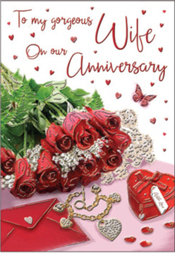 This anniversary card design unfolds like a tender scene from a home in Canonbury at golden hour, where soft natural light brushes over every object with affection. A compact but luxurious cluster of red roses sits prominently in the foreground, their petals layered in sumptuous spirals that invite the mind to imagine their familiar, comforting fragrance. The blooms are framed by sprigs of vivid greenery, adding freshness and life, as if freshly arranged by a local florist just off Essex Road. Beside the flowers lies an elegant envelope, part-open, paired with a dainty piece of jewellery and a petite heart-shaped keepsake box, their metallic details gently gleaming rather than shouting for attention. Tiny scatterings of red hearts and a single butterfly motif float across the surface, giving the composition a sense of movement, like confetti drifting down after a quiet celebration. The background is intentionally soft-focus, a pale, shimmering base that lets the reds, greens, and subtle golds glow like embers. Every element feels thoughtfully curated, the way Canonbury couples might curate their own treasured mementos: simple, meaningful, and deeply personal. The script on the card is delicately styled, its flowing lines suggesting words of gratitude, loyalty, and affection, even if they can't be fully read. The entire image captures that reflective moment just before an anniversary surprise is opened-perhaps after a walk along the New River Path-when anticipation, memory, and love blend together as seamlessly as this artful arrangement of roses, keepsakes, and quiet light.