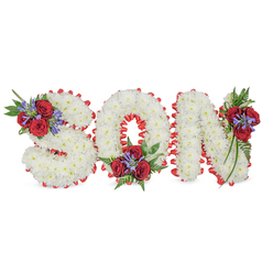 A lovingly crafted funeral tribute that spells SON in bold, sculpted letters, each formed from densely packed, pristine white chrysanthemums that create a soft, cloud-like texture across their faces. The letters sit on a clean white field; each is outlined with a vivid red satin ribbon folded into a scalloped border that crisply frames the white blossoms and gives the arrangement a formal, timeless silhouette. Three tasteful accent clusters add colour and movement: a spray of deep red roses and tall, blue-purple Liatris-style spikes rests on the upper left curve of the S; the O is punctuated by a compact cluster at its lower centre; and the N carries a trailing composition on its upper right shoulder. Dark green foliage, including feathery fern fronds and glossy trailing leaves, softens the joins and offers a restorative green counterpoint to the white and red. The roses bring a velvety, warm note, the chrysanthemums a quiet, clean purity, and the spiky blue accents add an elegant architectural lift. This arrangement, often chosen by families attending services at nearby churches or chapels around Essex Road and Canonbury, expresses enduring love and solemn respect. As a local florist with roots in the neighbourhood, Canonbury Flowers designs these personalized letter pieces to sit gracefully at wakes, funeral services or graveside commemorations, where their texture, scent and careful construction offer comfort and a clear visual message of remembrance.