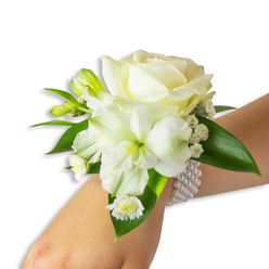 This wrist corsage is a study in refined white-on-green elegance, composed to be both wearable and quietly emotive. Center stage is a creamy ivory rose, its petals rolling outward in a plush spiral that holds the eye and invites a fingertip to trace its softness. Just below and a touch left, a trumpet-shaped white bloom - most likely an Alstroemeria (Peruvian lily) - opens with slender, slightly ribbed petals and a pale green-yellow throat that adds a whisper of colour and botanical intrigue. Flecks of tiny white Baby's Breath are woven through the composition, creating gentle texture and a feeling of lightness, while several vivid green buds remain closed, suggesting promise and continuity. A cluster of small daisy-like blooms with bright yellow centres nestles toward the wrist, adding a playful punctuation against the more formal rose. Deep, glossy green leaves, broad and smooth, cradle the flowers and offer a fresh, verdant contrast. The arrangement is secured by an elegant, elastic multi-strand pearl bracelet whose uniformly round pearls radiate a soft, luminous sheen and rest snugly against the skin. There is a faint, clean scent of cut flowers - rose sweetness tempered by green undertones - that follows each movement. Crafted with the proportions and restraint suited for weddings, proms, or milestone evenings, this corsage expresses quiet sophistication and the gentle joy of marking an important moment.