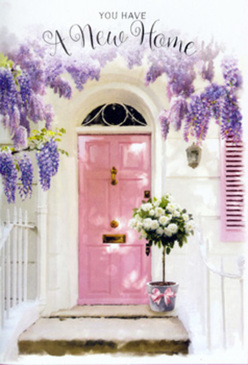 A charming doorway scene in Canonbury captures the quiet joy of moving into a new home, with cascades of lavender wisteria spilling gracefully over a pastel pink front door. The door, painted in a soft, almost chalky blush, stands out against weathered white walls that could belong to one of the calm, leafy streets near Canonbury Square. Above, the wisteria vines twist and drape, heavy with clusters of delicate purple flowers that seem to release a gentle, honeyed fragrance into the warm air. At the base of the door, a chic metal bucket in a subtle grey tone holds a generous arrangement of white and cream roses, each petal layered and plush, nestled among touches of fresh green foliage that add lightness and movement. A pale pink ribbon is tied around the bucket, its bow slightly relaxed, suggesting a hand-tied finish from a nearby artisan florist. Soft natural light filters across the stone steps, creating faint shadows from the trailing blooms and hinting at a peaceful afternoon in this corner of North London. The composition feels tender and inviting, as though the flowers have just been delivered to mark a housewarming or new tenancy, ready to greet friends and family stepping through the door. This scene, lovingly imagined by Canonbury Flowers, reflects the area's understated elegance: romantic but not fussy, refined but full of heart, a delicate floral welcome perfect for celebrating new keys, new stories, and a new address in Canonbury.
