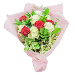 This stunning bouquet, crafted by a Canonbury florist and inspired by the leafy lanes and calm ambiance of the neighbourhood, features an exquisite blend of prominent red and creamy white roses. The white roses, radiant and full, evoke a sense of purity and new beginnings, reminiscent of dew-kissed mornings by Canonbury Square. In contrast, the crimson red blooms pulse with intensity and ardour, speaking of deep love and celebration. Both are carefully nestled among an abundant layering of garden-fresh foliage-glossy ruscus, supple eucalyptus, and pale, dotted sprigs with creamy variegation-each leaf adding distinctive shape and texture to the overall composition. The bouquet is cradled in layers of blush-pink tissue paper, its soft translucence reflecting ambient light in a gentle chorus with the blooms. The scent is a graceful mingling of fresh greenery and the sweet, familiar perfume of roses, evoking memories of Canonbury's thriving pocket gardens. Arranged in a classic, gently domed silhouette and expertly tied at the base, this bouquet captures both visual harmony and tactile luxury. The design is perfect for expressing heartfelt congratulations, romantic devotion, or to simply brighten a loved one's home, echoing the warmth and artistry you'll find at any trusted Canonbury floral shop.