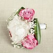 A romantic bridesmaid posy, fresh from a Canonbury florist's workbench, is set against a gently woven neutral fabric reminiscent of artisan markets along Upper Street. Three vividly open pink roses-petals swirling from deep berry edges into soft blush and pastel lavender at their centers-are cradled by a billow of creamy white peonies, each ruffled petal layered for a dreamy, gentle fullness. Around them, sprigs of dainty baby's breath float, creating the illusion of a soft morning mist and imparting a touch of magic to the ensemble. The arrangement is encircled with smooth, deep green leaves, their broad, glossy surfaces echoing the lushness found in Canonbury's secret gardens. Bound in a crisp white satin ribbon, the stems extend in a neat handle, suggesting careful, loving preparation for a celebration of love and new beginnings. The soft, even light highlights the delicate texture of every petal and the subtle interplay of whites and pinks, while the natural linen background allows the bouquet's joyous colours to glow. Created for weddings, anniversaries, or milestone events in Canonbury, this bouquet's fragrance, touch, and timeless beauty invite anticipation and cherished memories-an elegant embrace from a local expert, perfect for honouring life's most heartfelt moments.
