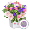 A vibrant engagement bouquet, carefully crafted by Canonbury Flowers, is presented in a pristine white square box. The arrangement glows with soft pink roses at various stages of blooming, nestled beside cheerful pastel pink gerbera daisies with crisp white edges and pale yellow centers, all set against lush green foliage. Scattered clusters of deep purple filler blooms add depth and a touch of drama, completing a fresh, garden-inspired look. A round foil balloon sits to the lower right, its surface a gentle lavender hue and bearing the words You're Engaged! in glittering silver lettering, with the O in You're stylized as a sparkling golden engagement ring framed by a white rim dotted with tiny hearts and silver stars. The front of the box carries a discreet red rose emblem, hinting at the artistry inside without overt branding. Designed for Canonbury and the surrounding Islington area, this gift speaks of celebration, romance, and new beginnings, ideal for congratulating a newly engaged couple. Available for same-day delivery across Canonbury, Islington, and nearby streets such as Upper Street and Essex Road, it brings warmth and joy into any home while staying elegant and modern.