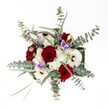 Gazing down upon this lush, locally crafted bouquet is like witnessing a pocket garden of Canonbury in full bloom. Plush crimson roses, their petals gently spiralled, immediately command attention with a depth that feels at once timeless and intimate-a nod to the classic romance often found in Canonbury's secret gardens. They are flanked by bold white gerbera daisies, their dark hearts adding a dramatic contrast and a spark of modern flair. Scattered between these anchors, petite sprays of white chrysanthemums bring an airy softness, mirroring the soft cloudscapes over Canonbury Park. Pale lilac Lisianthus shyly peep through, their silky blooms providing subtle color and a soothing, almost meditative presence. All are framed by cool, rounded eucalyptus, whose misty green leaves curl outward, lending both freshness and a calm sense of order to the vibrant mix. The meticulous arrangement of each flower, thoughtfully set atop a crisp white canvas and bathed in abundant daylight, speaks to the dedication and intuition of the local Canonbury Flowers team. Whether gifted for an anniversary, birthday, or as a centrepiece for a thoughtful gathering amongst friends and neighbours, this bouquet radiates warmth, harmony, and the quiet sophistication that defines Canonbury living.