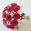 Gathered in the heart of Canonbury, this vibrant and sumptuous bouquet draws attention to its perfectly formed, fully bloomed red roses, their petals soft to the touch and rich with classic romantic fragrance. Dotted with generous clouds of white baby's breath, each delicate cluster accentuates the intensity of the crimson and creates a dreamy, uplifting contrast, reminiscent of early morning walks along Canonbury Grove. Subtle hints of deep green foliage peek through, their texture grounding the arrangement and evoking local spring gardens. The bouquet is thoughtfully gathered and bound with a wide, silky red ribbon embossed with clean white stripes-its elegance heightened by a gentle spiral of shining white pearls, a nod to Islington's timeless sophistication. The fresh green stems at the base are left neatly exposed, their cut edges crisp and vibrant, underscoring the care in each hand-tied detail. Bathed in soft, even light, the scene captures every layer and color, inviting feelings of joy, love, and promise-perfect for brides, anniversaries, or romantic moments across Canonbury. Made for those who appreciate meaningful gestures, this bouquet is meticulously created by the skilled hands at Canonbury Flowers, ready for delivery to cherished celebrations throughout the area.
