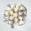There's a gentle grace to this Canonbury bouquet, as if it captures the hush of a tranquil morning by Newington Green. At its core, snowy white roses bloom in plush, spiralled layers, exuding hope and the gentle confidence of new beginnings. Pale lavender statice threads delicately between each bloom, their tiny clustered florets imparting a soft, lacy texture against the roses' sleek petals. The entire arrangement sits against a white-washed background, the freshness of every blossom heightened by crisp, natural daylight streaming in, evoking the quiet energy of Canonbury's historic terraces. There's a sense of softness-almost velvet-inviting the fingertips, with green foliage providing subtle structure and freshness. This bouquet radiates calm reassurance and luminous purity, making it a meaningful gift for moments of comfort, heartfelt celebration, or simple acts of kindness. Thoughtfully designed and available for delivery across Canonbury, its quiet beauty lingers in the memory, much like the trace of morning dew on a garden bloom.