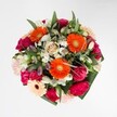 A celebration of colour, scent, and texture, this vibrant floral arrangement bursts with the spirit of Canonbury and brings the essence of its gardens indoors. Orange gerberas, alight with energy, radiate from the centre, their bold petals gleaming like rays of morning sun filtering through leafy avenues around Canonbury Square. Magenta carnations, deeply pigmented and soft as velvet, form plush accents beside the creamy, blush-tinged roses that feel freshly gathered after rainfall. Scattered throughout, snowy white alstroemerias and dainty daisies impart a light, dewy freshness, as if a cool breeze from New River Walk has just swept over the bouquet. Every bloom is framed with abundant greenery-glossy and rich, yet never dominating-which provides a sense of fullness and life. The artful blend of rich and delicate tones, anchored by thoughtful design and an inviting fragrance, makes this bouquet an ideal gift for birthdays, joyful milestones, or simply to brighten a Canonbury living room. Its harmonious arrangement speaks of warmth, community, and the timeless appeal of expertly chosen, locally grown flowers.