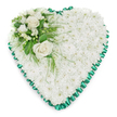 Refined heart-shaped sympathy tribute composed predominantly of pure white chrysanthemums, ideal for a quiet farewell in Canonbury's churches and crematoria. The heart's surface is densely carpeted with small, tightly clustered chrysanthemum blooms, giving a plush, cloud-like appearance with intricate layers of petals catching the soft light. This uninterrupted blanket of white suggests innocence and serenity, offering visual comfort during moments of grief. Encircling the entire design is a deep emerald green satin ribbon, pleated into even, ruffled segments that form a scalloped border. The ribbon's rich colour and gentle sheen frame the heart clearly against the bright white background, creating a graceful outline that guides the eye. In the upper left curve sits a thoughtful focal arrangement: two open white roses with creamy centres, their petals gently curling outward, surrounded by smaller white flowers - likely freesias or similar delicate blooms - that contribute a sense of light fragrance and fine texture. Interwoven around this cluster, lush greenery adds contrast and depth: broad, polished leaves provide structure while airy, feathery fronds soften the edges and drift lightly over the chrysanthemum base. The balance of white and green feels harmonious, like a calm moment in one of Canonbury's tree-lined streets or a shaded corner of nearby Highbury Fields. Every element is placed with care, suggesting the work of an experienced local florist who understands the needs of bereaved families. This heart-shaped floral piece is suited to coffinside tributes, chapel displays, or placement at a graveside, expressing love, respect, and a gentle promise of remembrance.