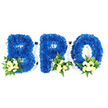 An intimate, eye-level studio portrait set against a clean, stark white background: three freestanding capital letters - B, R and O - sculpted entirely from dense, royal blue chrysanthemum florets. The petals are closely packed to form plush, sculptural letterforms with crisp edges; the white supporting base or foam frame is subtly visible along the inner loops of the B and R and the circular centre of the O, grounding each piece with a precise, architectural silhouette. At the base of each character a gentle cluster of pale ivory spray roses and small white filler blooms nestles into glossy green foliage - a mix of broader salal or lemon-leaf and lighter, fern-like fronds - the accents placed at the lower-left of the B and at the lower-right of the R and O, giving the composition a balanced, intentional rhythm. Under soft, even lighting the royal blue reads saturated and velvety, the cream roses offering quiet contrast and an almost powdery, comforting scent against the cooler blue tones. The texture alternates between the dense pompom quality of the chrysanthemums and the softer, layered petals of the roses, while the greenery adds depth and a faint leafy freshness. The overall effect is reverent and composed - a bespoke sympathy tribute designed to convey remembrance and respect for a lost brother or close friend. As a local florist familiar with Canonbury and nearby Essex Road, I picture this arrangement placed with dignity at a memorial service or wake, its deep blue suggesting peace and fidelity and its light cream accents suggesting solace and purity in a time of mourning.