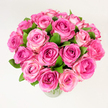 A sumptuous, lush bouquet of roughly two dozen pink roses sits poised in a simple clear glass vase, photographed against a clean, uniformly lit white backdrop. The composition is densely packed and rounded, each rose fully or nearly fully open so that layers of velvety petals ripple outward from tight, deeper-coloured centres. The palette moves from a rich fuchsia or magenta in the heart of some blooms to softer rosy pinks and delicate blush tones at the petal edges, creating a natural ombré that gives the arrangement depth and a sense of movement. Small sprays of dark, glossy green leaves are tucked between the blooms, their cool tones sharpening the warmth of the pinks and lending a freshly cut, garden-picked feel. The image is taken from a slightly elevated, overhead angle, which emphasises the bouquet's generous fullness and its harmonious rounded silhouette, inviting the viewer to imagine its weight in the hands and the soft friction of petals against fingertips.
Under soft, diffuse daylight the surface textures-the satiny sheen of petals, the matte veining of leaves, the faint reflection on the vase-are gently revealed, while a subtle rosy scent seems almost present in the picture. This arrangement carries a mood of celebration and tender affection: it reads as a romantic gesture, a Mother's Day surprise, or an elegant centrepiece for an intimate anniversary dinner. For someone in Canonbury or nearby on Essex Road or Angel, the bouquet suggests local craftsmanship and thoughtful selection of blooms, perfect for marking a joyful moment with colour, scent and classic floral beauty.