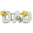 A tender, three-dimensional memorial spelling the word DAD in large freestanding capital letters, each letter built from a dense, cloud-like blanket of small white blossoms that read as pristine spray carnations or chrysanthemums. The outer contours are edged with a slender ribbon of emerald-green foliage or ruffled satin, a cool, crisp line that gives each letter definition against the plain white background and softens the overall silhouette. On the leftmost D a joyful cluster of bright yellow roses rests on the upper curve, arranged with tiny creamy freesia or gypsophila accents and fresh, glossy leaves that lend a soft, reassuring fragrance. The central A receives a quieter, more reflective accent of purple-lilac blooms - suggestions of lilies or stock - nestled low along one diagonal, their deeper tones creating a respectful focal point amid the white. The rightmost D mirrors the left, repeating that sunny cluster of yellow roses and white fillers so the design feels balanced and intentional. Thin, dark-green support bars run horizontally behind the letters, visible through gaps in the flowers and anchoring the trio as a single, stable composition meant to stand at a funeral, wake, or memorial service. In soft morning light the textures read as velvety and tactile, the roses carrying a gentle sweetness while the white florals offer a clean, comforting scent. As a local florist working around Canonbury Square and the New River Walk, I imagine this tribute placed near a chapel or graveside in Canonbury - a handcrafted statement of love, memory and calm that comforts through thoughtful colour, proportion and craft.