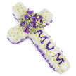 A tender, cross-shaped funeral tribute assembled from a dense carpet of small, pure white chrysanthemum heads that create a pillowy, cloud-like surface. Each chrysanthemum is placed closely to form the substantial body of the Christian cross, the downy petals catching a soft, cool light that emphasises their creamy whiteness and quiet dignity. Around the entire perimeter a ruffled satin ribbon in deep lilac-to-purple is gently woven, its pleats offering a solemn, elegant frame and a subtle sheen against the matte petals. Down the vertical arm the word MUM is carefully spelled in rich purple flower heads - likely compact lisianthus or spray chrysanthemum blooms - their saturated tones standing out clearly against the white background and delivering a personal message of love and remembrance. At the centre where the arms meet, a lush focal spray gathers together deep violet roses and paler lavender lisianthus, the roses' tight spirals contrasting with the lisianthus' ruffled cups; variegated greens with light-edged leaves and darker centres tuck between the blooms, adding crisp texture and nodding to renewal. Small, round green berries are threaded through the cluster for punctuation and subtle contrast. The arrangement sits cleanly against a bright white backdrop, the cool palette of whites and purples suggesting purity, peace, and reverence. There's a faint, powdery floral scent - a soft mix of rose and chrysanthemum - that feels like a calm breath in a quiet chapel. This cross is designed to offer solace and a tangible expression of enduring affection at a funeral, memorial service, or graveside gathering in and around Canonbury and neighbouring Islington chapels.