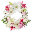 A large circular sympathy wreath is shown in full view against a clean white background, its unbroken ring densely woven with white, blush pink, and vivid fuchsia flowers that convey both peace and heartfelt remembrance. Dominating the design are generous white Oriental lilies, fully open with gently recurved petals that feel almost velvety to the eye, each bloom revealing soft green centres and golden stamens that catch the light. Interspersed between these serene whites are deep pink and magenta lilies, star-shaped and sometimes delicately speckled, adding a rich, warm contrast that keeps the arrangement from feeling stark. Nestled among the lilies are clusters of soft, light pink roses and creamy white roses, some still in bud and others fully unfurled, their layered petals suggesting tenderness, sympathy, and enduring love. White gerbera daisies appear throughout the wreath, their dark central disks and crisp, evenly spaced petals lending a clean, modern touch reminiscent of stylish flower displays in Canonbury and along nearby Essex Road. Smaller white filler flowers, such as tiny carnations or sprays of chrysanthemums, tuck into every remaining space, creating a plush, continuous texture with no hard edges. A foundation of lush greenery wraps around the wreath, with dark and mid-green leaves providing depth, framing the flowers, and echoing the quiet greenery of Canonbury's residential streets. The soft, even lighting allows the whites to glow and the pink tones to appear rich yet gentle. This circular wreath, symbolising eternity and the unbroken cycle of life, would be a thoughtful floral tribute for a funeral, memorial, or celebration of life service in Canonbury or the wider Islington area, conveying respect, comfort, and sincere condolences.