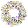A tender ring of flowers stands out clearly against a bright white background, its perfectly round shape suggesting both wholeness and gentle continuity. The majority of the wreath is composed of Baby's Breath, each fine stem branching into tiny white blossoms that crowd together in a soft, airy mass, like light mist over the tree-lined paths of Canonbury. This cloud-like texture forms a serene backdrop for the more prominent Lisianthus flowers, which are carefully spaced so that they appear to float upon the Gypsophila. Every Lisianthus bloom has delicately ruffled petals that open in concentric layers; their centres remain predominantly white, gradually giving way to edges that are traced with hues of lilac, violet, and deeper purple. The effect is painterly, as though each petal has been shaded by hand. Scattered among the open blossoms are a few partially closed buds, their outer layers still pale green with a blush of cream or soft yellow, hinting at the colour that will emerge as they fully unfold. The wreath's hollow centre is clearly defined, forming a tranquil space that draws the gaze inward and reinforces its use as a symbol of everlasting love and remembrance. There is no ribbon, text, or decorative hardware visible, only fresh flowers and the slightest suggestions of green stems, all lit evenly so that every detail is easy to distinguish. This kind of white and purple floral wreath, commonly prepared for funeral services, memorials, and moments of quiet reflection, feels like a gentle, respectful tribute chosen by families in Canonbury who value understated elegance and sincere emotion.
