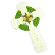Viewed slightly from above against a bright, clean white backdrop, this long, three-dimensional Celtic cross is lovingly constructed from fresh flowers and radiates quiet dignity. The main body is a dense, plush carpet of pure white spray chrysanthemums whose many small, feathered petals create a soft halo that absorbs the light and suggests purity and calm. Interwoven into that white base are panels of crisp, apple-green button chrysanthemums: compact, almost cushion-like spheres that trace the distinctive circular ring where the arms meet and appear again in alternating sections along the horizontal arms, lending depth and the woven geometry of Celtic knotwork. At the very heart of the cross, where memory and symbol converge, three fully opened orange-gold roses bloom together; their warm, sunlit tones pop against the cool white and fresh green and are gently set off by a few sprigs of deep green fern, which give a subtle, natural frame and a hint of woodland scent. Soft studio lighting sculpts the form and brings out the tactile contrast between the chrysanthemums' fine, airy texture and the roses' velvety petals. The composition reads as both a traditional memorial tribute and a contemporary piece of floral art - suitable for funeral services, graveside remembrance, or ceremonies that honour Irish heritage. As a local touch, this arrangement is the kind often chosen by families in Canonbury, quietly requested for services near Canonbury Square or delivered to churches around New River Walk, carrying a sense of reverence, comfort, and enduring memory.