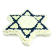 A beautifully symmetrical Star of David floral tribute dominates the image, laid out against a seamless white background that allows its colours and structure to stand out with clarity. The star's six points are built from a carpet of small, tightly massed chrysanthemums or similar blossoms, their multi-layered petals creating a plush, almost velour-like texture. A bold border of snowy white flowers traces the entire outline of the Magen David, while the central hexagon and the shorter inner triangles are likewise rendered in pure white, suggesting purity, peace, and remembrance. The interlocking triangles that form the main graphic of the Jewish symbol are filled with deep navy blue flowers, whose dark, saturated hue provides strong visual lines and an immediate sense of dignity. The repetition of white and blue gently recalls both traditional Jewish motifs and the Israeli flag, adding a layer of cultural resonance without overpowering the composition. The lighting is soft and even, picking up the subtle sheen on individual petals and the tiny shadows where blooms meet, so the design feels slightly raised, like a cushioned emblem. It is easy to envision this tribute being prepared for a Jewish funeral or yahrzeit service for a family in Canonbury, then carefully delivered to a synagogue or chapel near New River Walk. The arrangement carries a quiet emotional weight, combining careful craftsmanship with symbolism that honours the deceased's Jewish identity and the comfort of community during mourning.