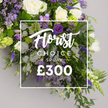 A richly abundant Florist Choice Spray by Canonbury Flowers sits against a soft grey studio backdrop, its luxurious profile framed by calm, natural light. The arrangement is opulent yet balanced, with ivory-white roses taking the lead, their satin petals opening in timeless elegance, paired with white lisianthus and slender white freesias that lend purity and a delicate fragrance. Purple accents appear through deep lisianthus, lavender-hued eustoma and freesias, and tall, elegant spikes of purple veronica or delphinium, which give the spray a stately vertical lift. Lush greenery-ferns and glossy leaves-provides a verdant boundary that enhances the sense of depth and movement. Set on a neutral background, a crisp white rectangular overlay frames the central message: Florist CHOICE SPRAY in white typography, Florist in a graceful script and CHOICE SPRAY in strong uppercase letters, with the price ?300 displayed in bold white numerals beneath. The result is a premium presentation that communicates craft, seasonality, and thoughtful design, suited for significant occasions from sympathy tributes to grand celebrations. This Canonbury creation embodies the local craft of Canonbury Flowers, designed for dependable delivery across Canonbury, Islington, and the surrounding streets such as Upper Street and Essex Road. It brings together fresh blooms, precise arrangement, and a refined mood-an offering you can trust to mark moments with elegance and grace.