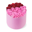 A vibrant two-tone rose gift sits in a light pink, matte, round cylindrical box, the lid removed to reveal a heart-shaped display across the top. The upper lobes of the heart are formed by about a dozen deep red roses, tightly clustered to create a bold, intimate line. The lower portion of the heart, made up of many blush pink roses, flows into a soft point, producing a graceful two-tone gradient. Each bloom is fully opened, petals folded into plush spirals that give the surface a plush, uniform texture. The box's pale pink matte finish contrasts with the white studio background, allowing the colours to glow and the craftsmanship to shine. This romantic arrangement is ideal for Valentine's Day, anniversaries, or special birthdays, and it also works beautifully in features about luxury gifting or premium same-day delivery in Islington. For Canonbury customers, bi-color rose boxes like this are a popular way to express affection at doorstep moments on Canonbury Place, Essex Road, or near Islington Green, delivering both elegance and a sense of joyful celebration.